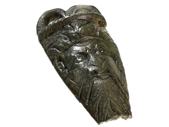 Early Roman bronze cauldron fitting or mount, in the form of the god Janus.