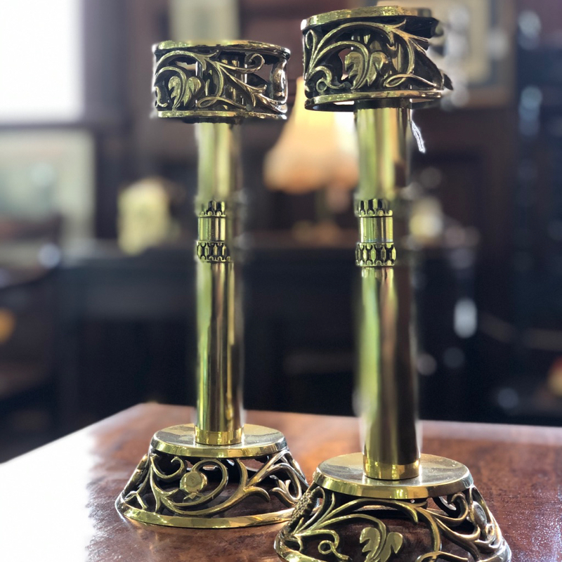 Pair of Art Nouveau brass candlesticks with pierced leaf and berry decoration